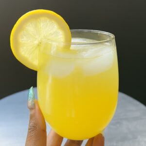 Refreshing cortisol cocktail made with lemon juice and sea salt in a clear glass, surrounded by clean kitchen ingredients.